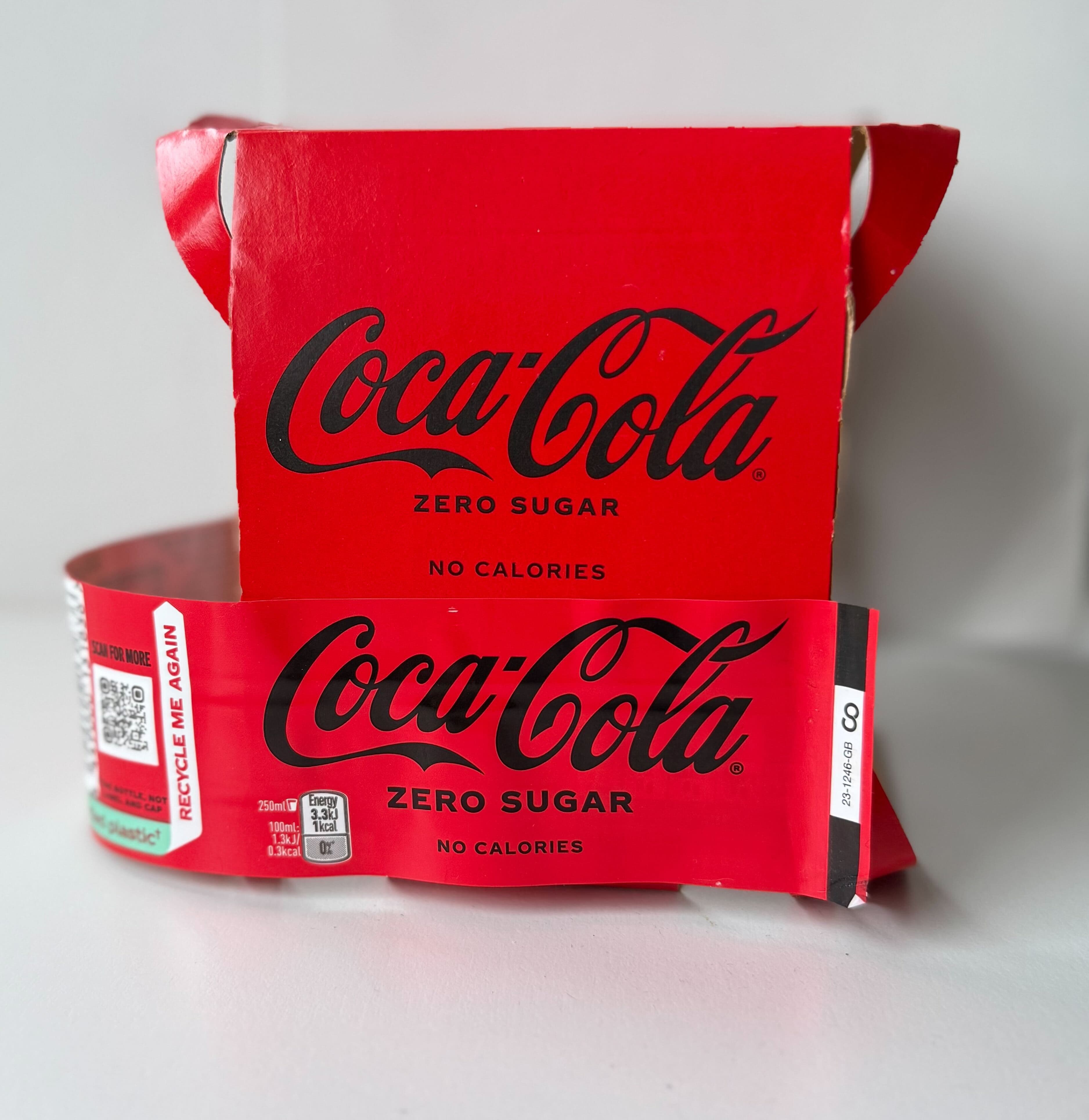 Paperboard box with plastic label overlaid